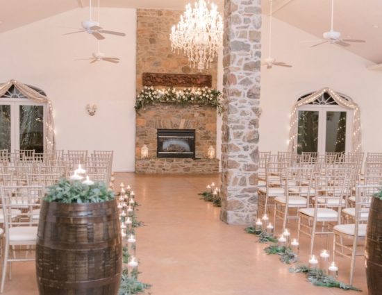 Large room with concrete flooring set up for wedding ceremony