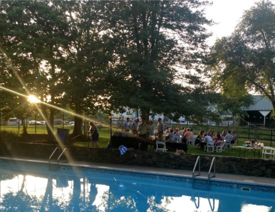 Wedding reception set up near pool with clear water