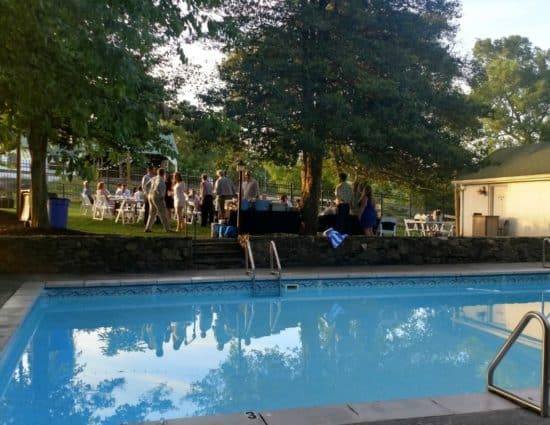 Wedding reception set up near pool with clear water