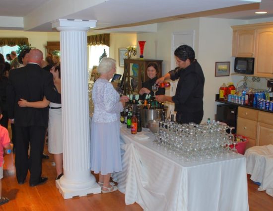 Wedding reception with people talking and standing at the bar