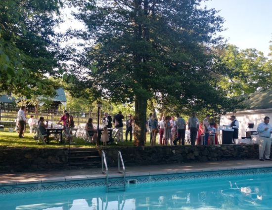 Wedding reception set up near the pool with clear water