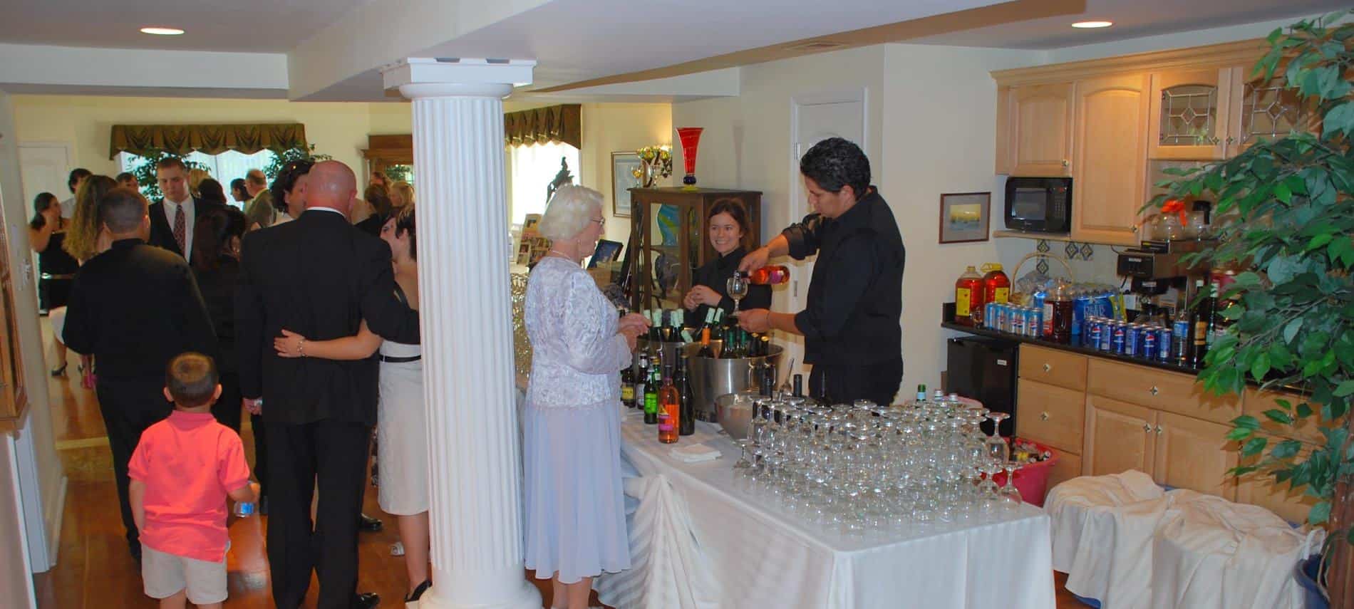 Cocktail reception with guests talking and getting drinks at the bar